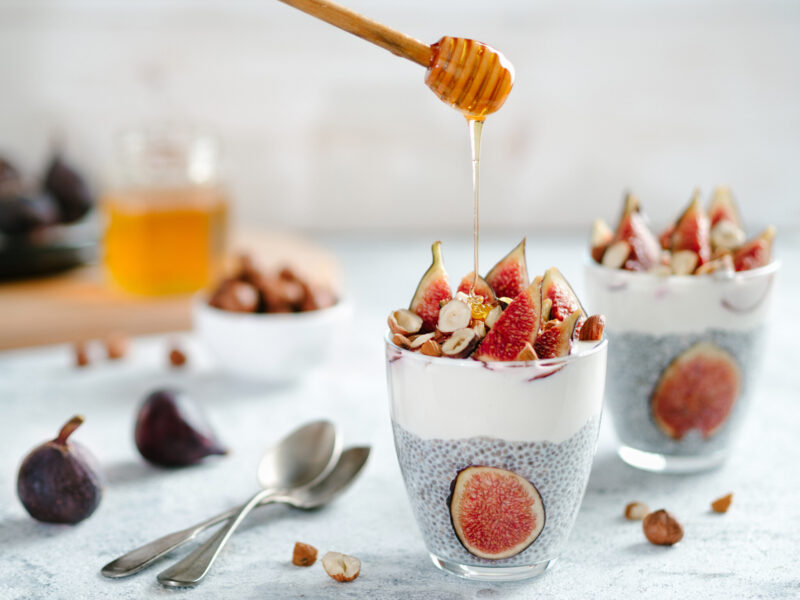 Chiapudding with yoghurt, figs and nuts in a glass.